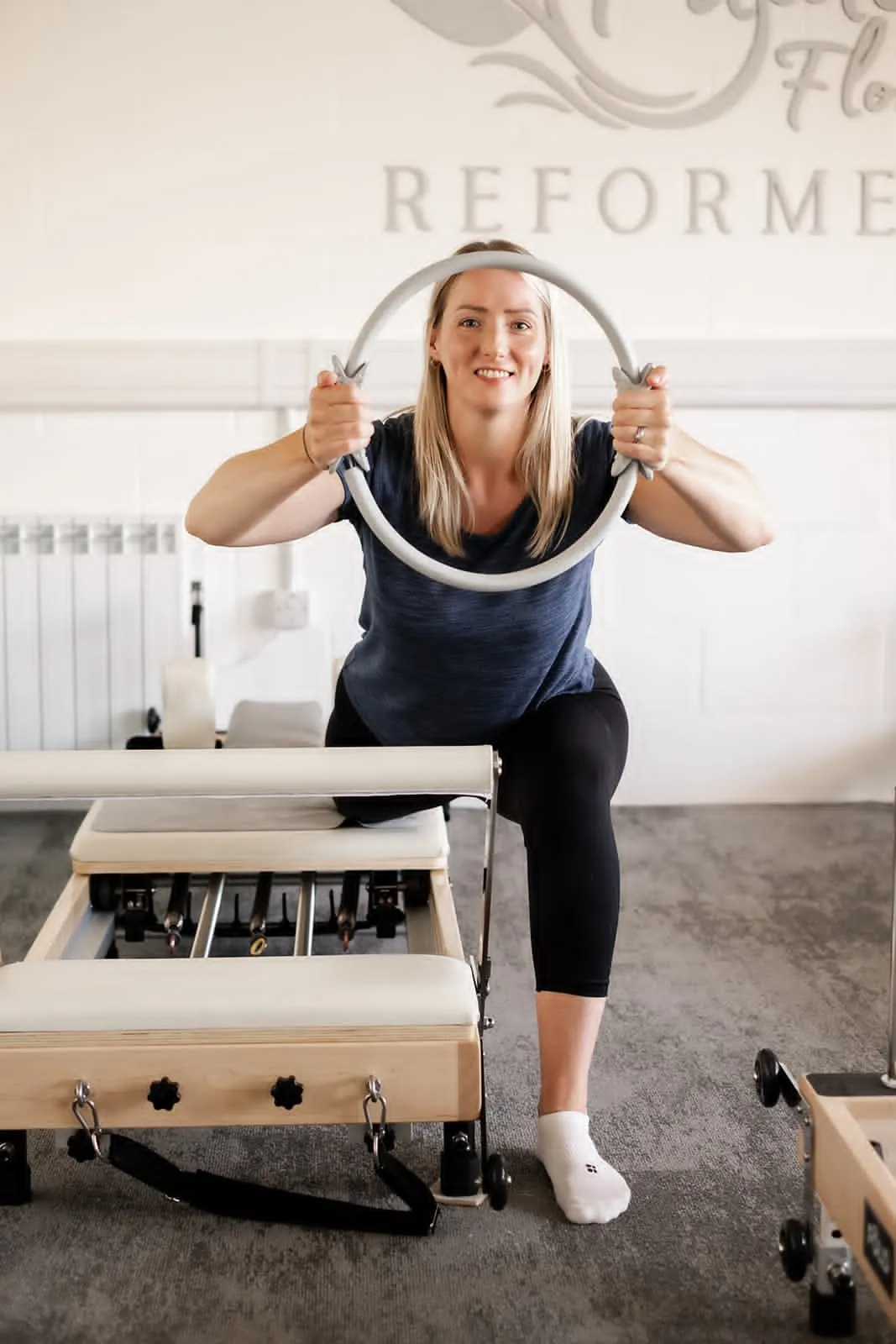 Client holding a Pilates ring in the Quedgeley reformer studio